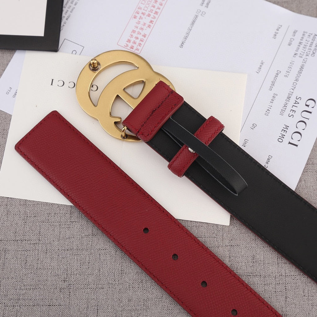 Red and black belt with gold double-G buckle, belt holes visible