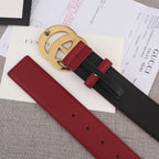 Red and black belt with gold double-G buckle, belt holes visible