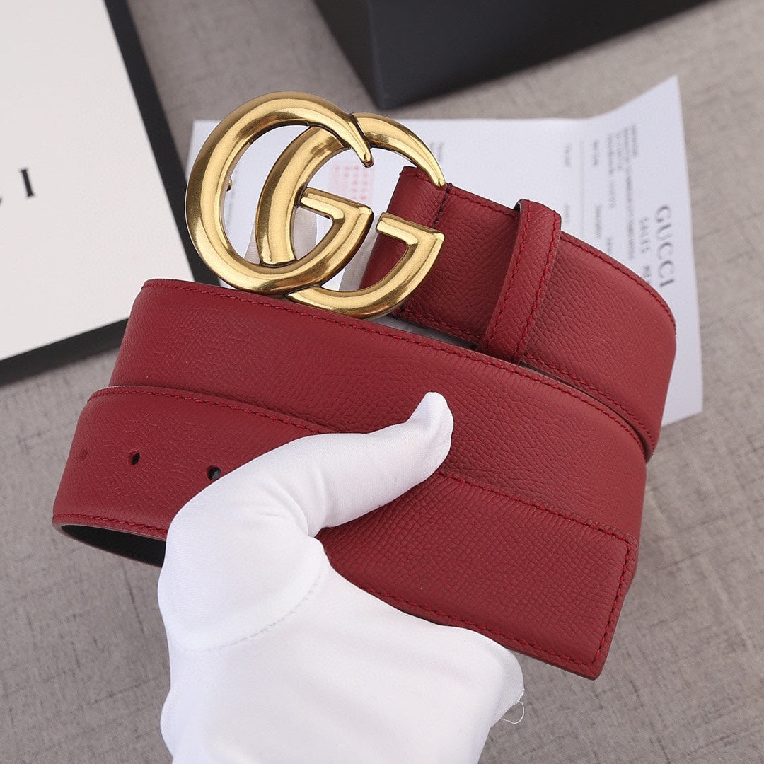 Red leather belt with gold double-G buckle, showing inner black panel
