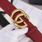 Red leather belt with gold double-G buckle and textured strap detail