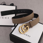 Brown leather belt with gold-tone GG buckle and adjustable strap end