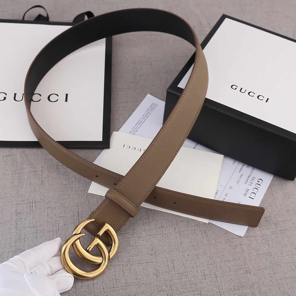 Brown leather belt with gold-tone GG buckle and leather strap loop