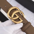 Brown leather belt with gold-tone GG buckle and punched holes