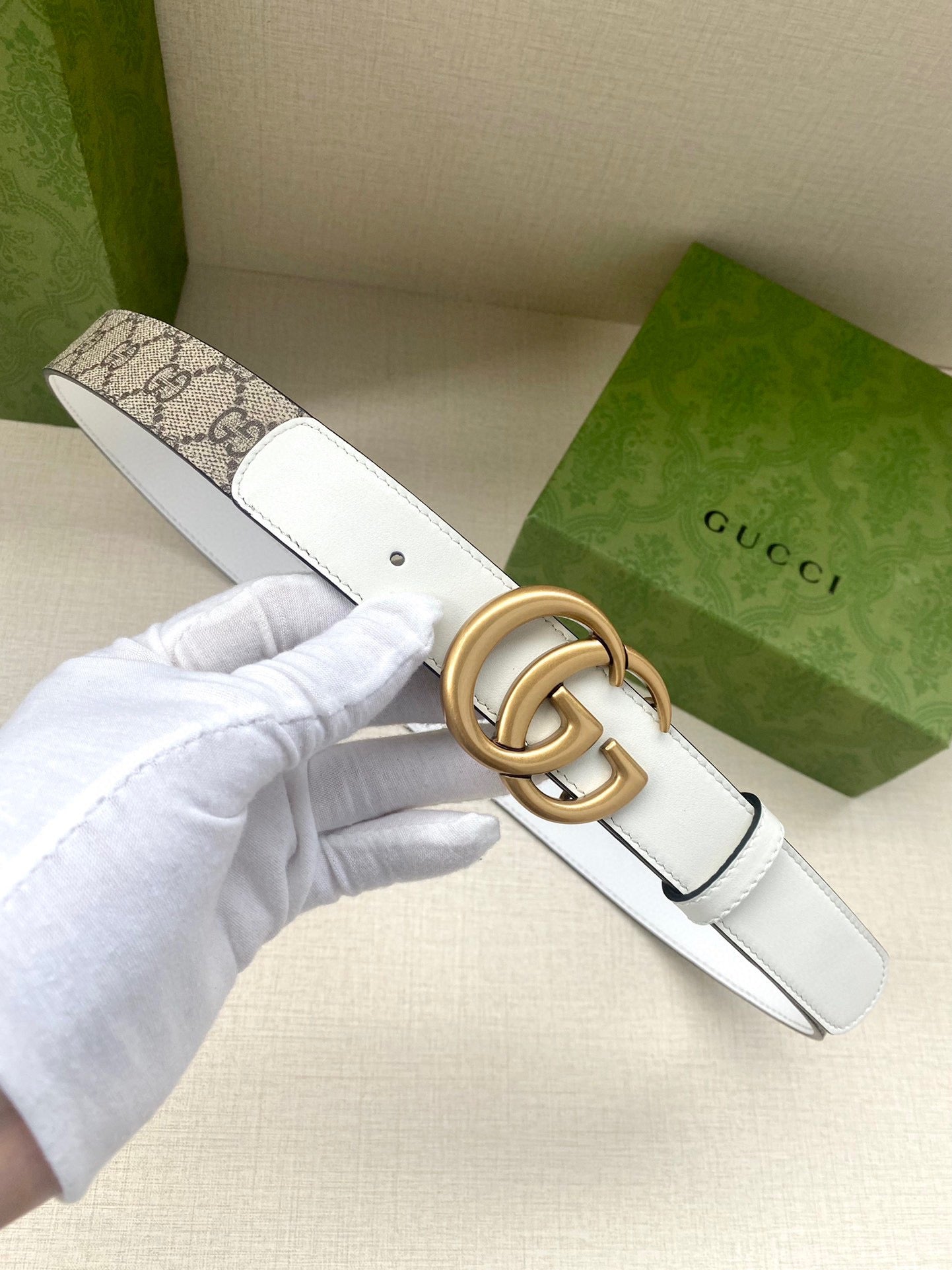 Gucci belt with GG canvas strap and gold-tone double G buckle