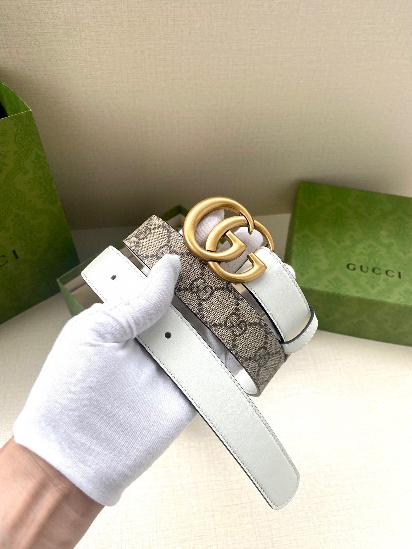 Gucci belt with monogram canvas strap and gold-tone double G buckle
