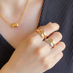 Chanel accessories rings on hand: two-tone gold and silver stacked bands with diamond accents