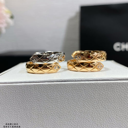 Chanel accessories rings: two stacked gold and silver bands with diamond accents, side view