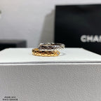Stacked rings with silver-tone top band and gold-tone bottom band, lattice design