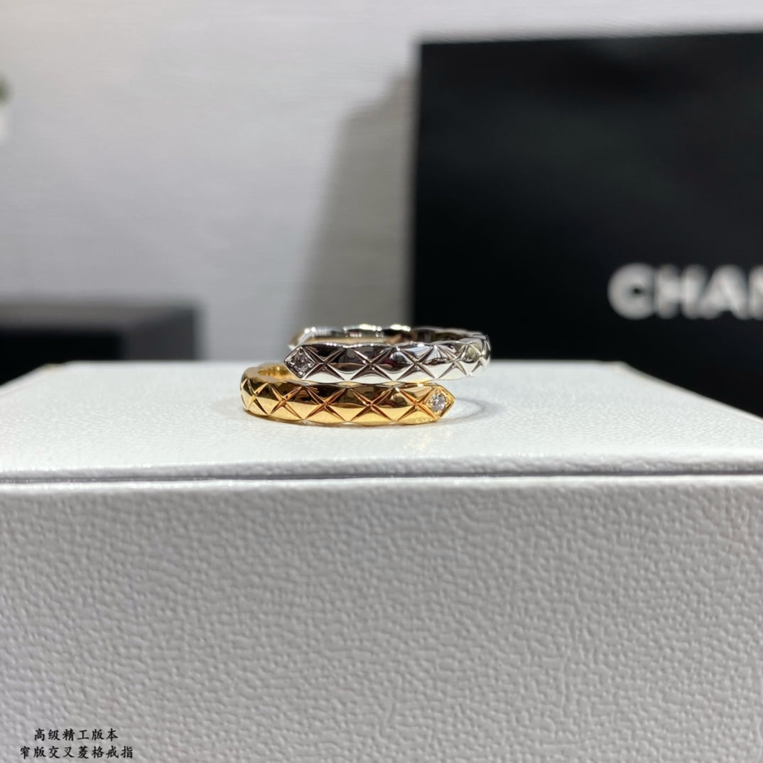 Stacked rings with silver-tone top band and gold-tone bottom band, lattice design