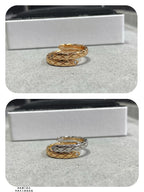 Gold-tone and silver-tone rings shown in a white jewelry box