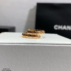 Gold-tone ring with diamond lattice pattern and small clear stone accents