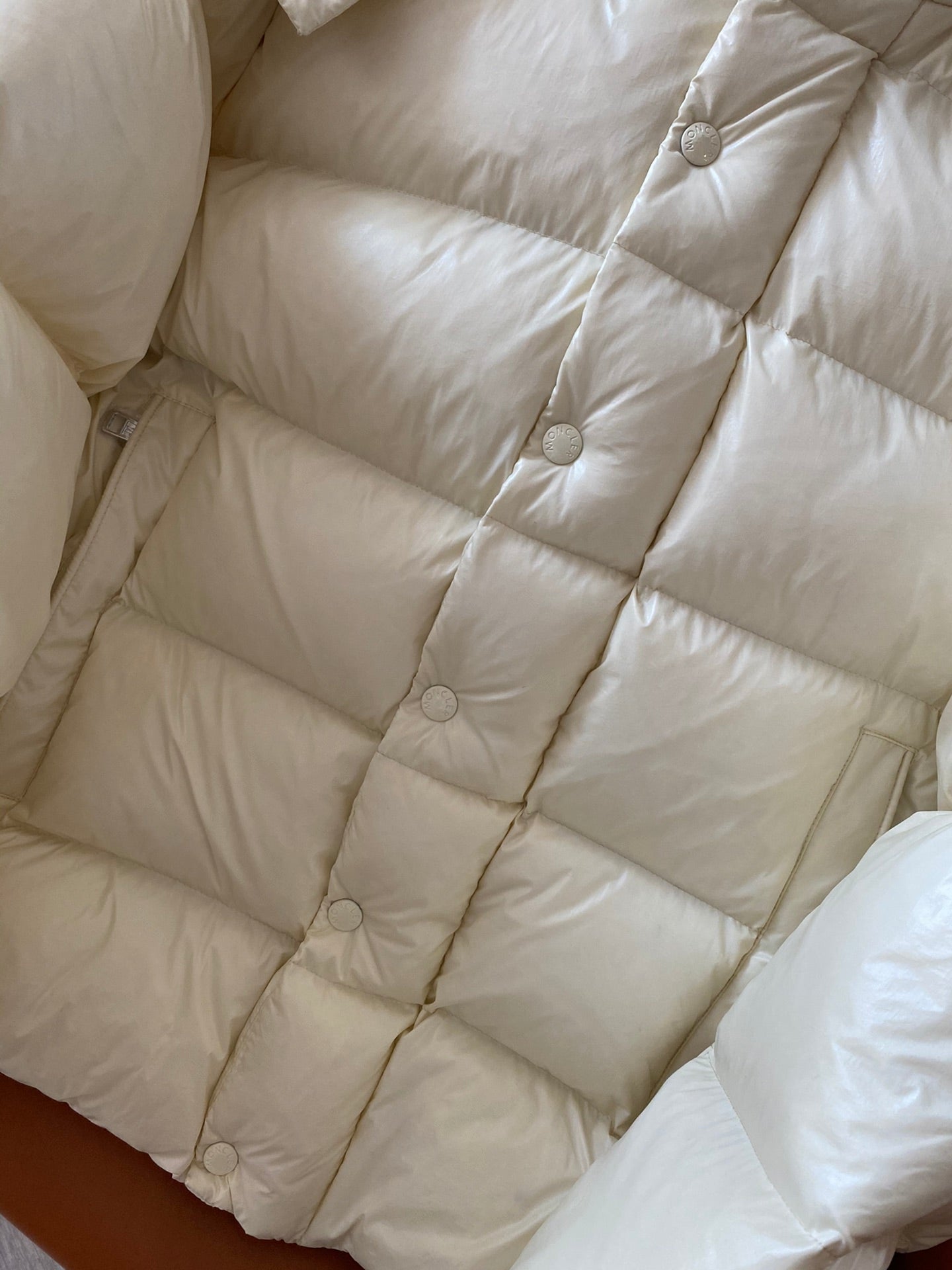 Moncler long cream puffer jacket back with stitched quilted panels and snaps