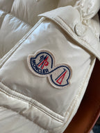 Moncler long cream puffer jacket sleeve with embroidered logo patch