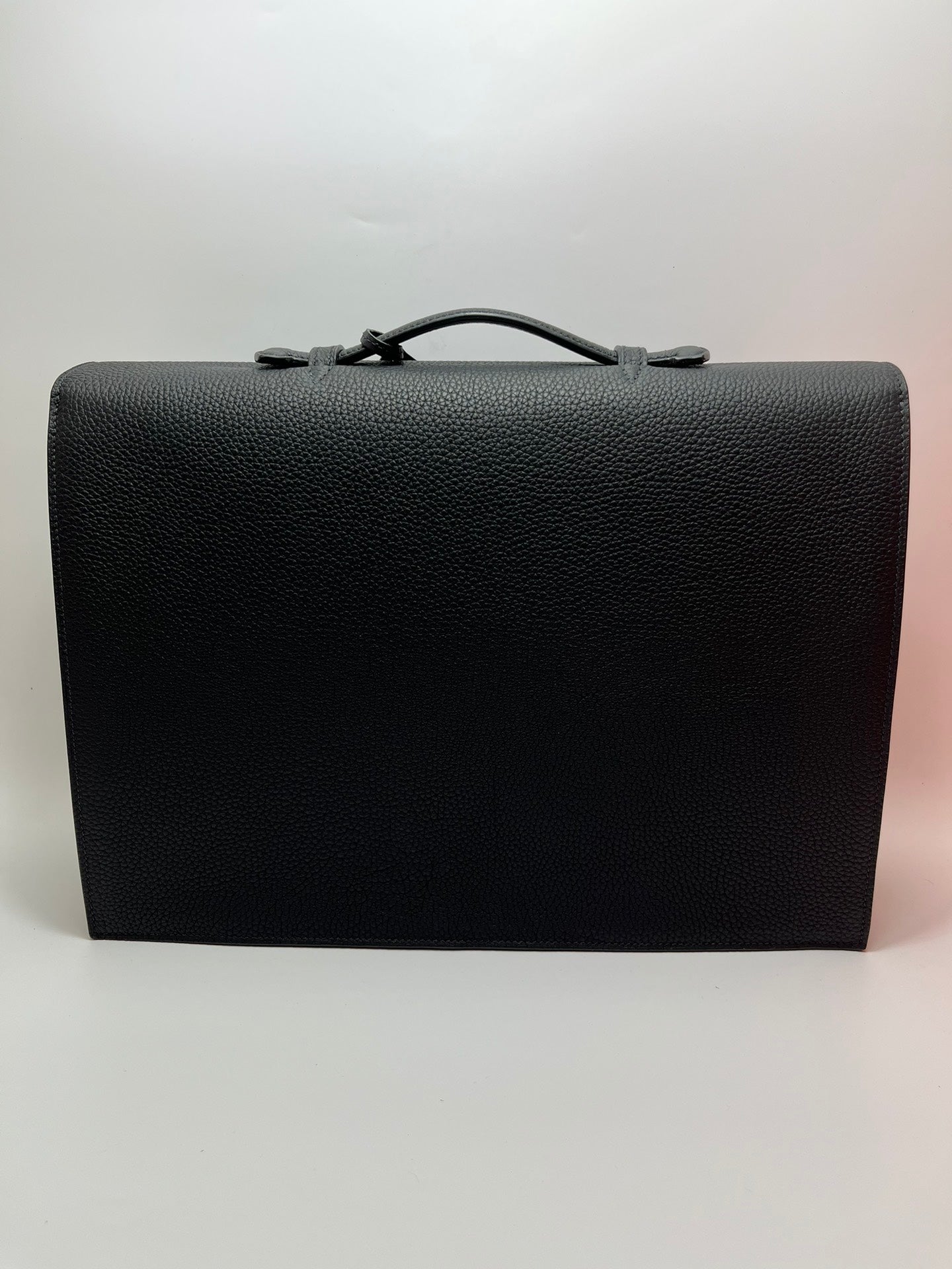 Dark gray leather satchel bag with structured front flap and top handle