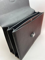 Dark gray leather satchel bag with burgundy inner lining and clasp detail