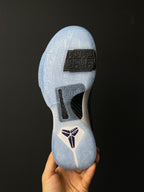 Basketball shoe outsole view, light blue traction pods with black forefoot label.