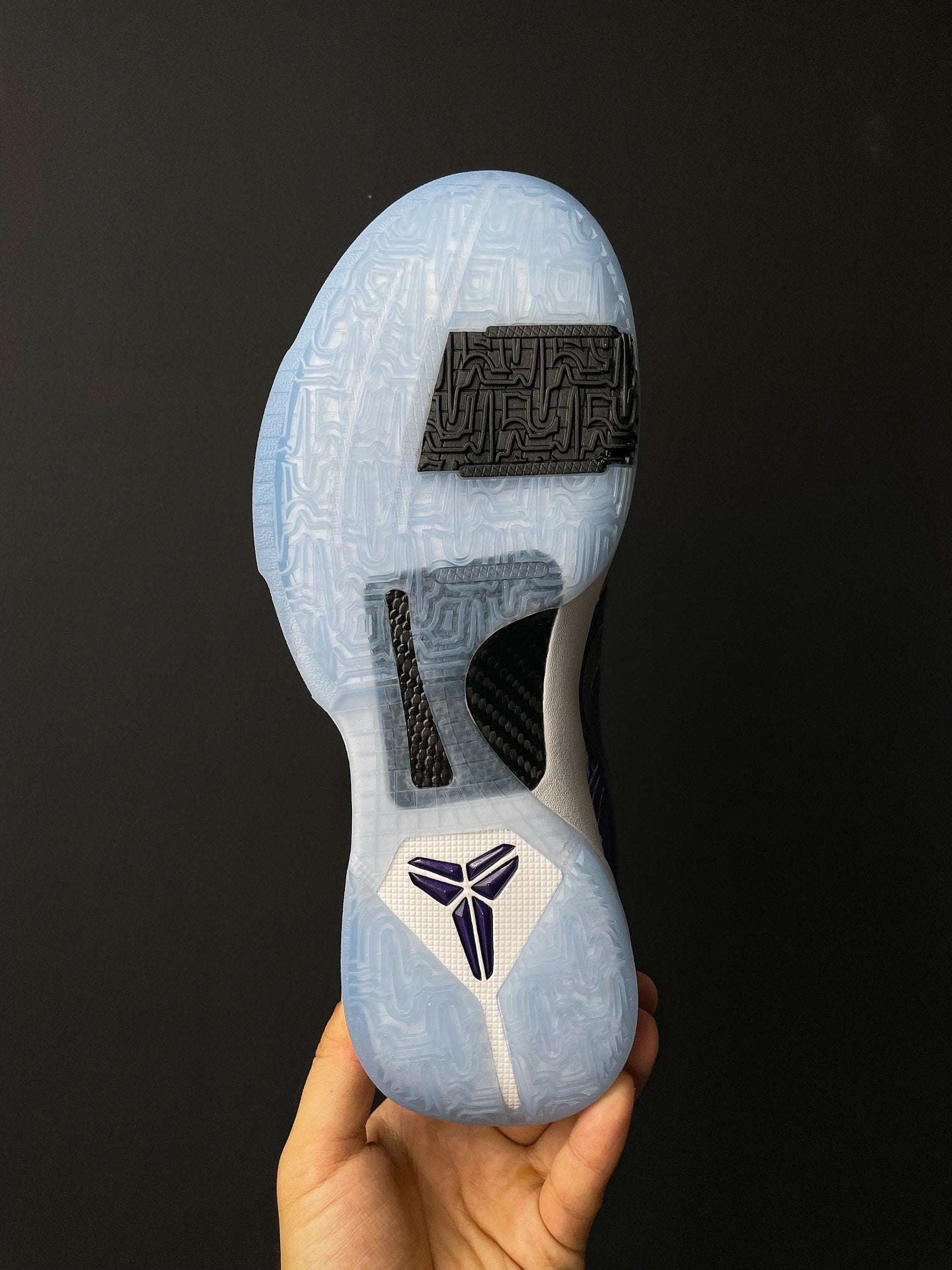 Basketball shoe outsole view, light blue traction pods with black forefoot label.