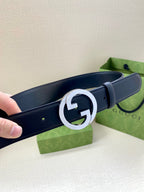 Navy leather Gucci belt with large silver GG buckle detail