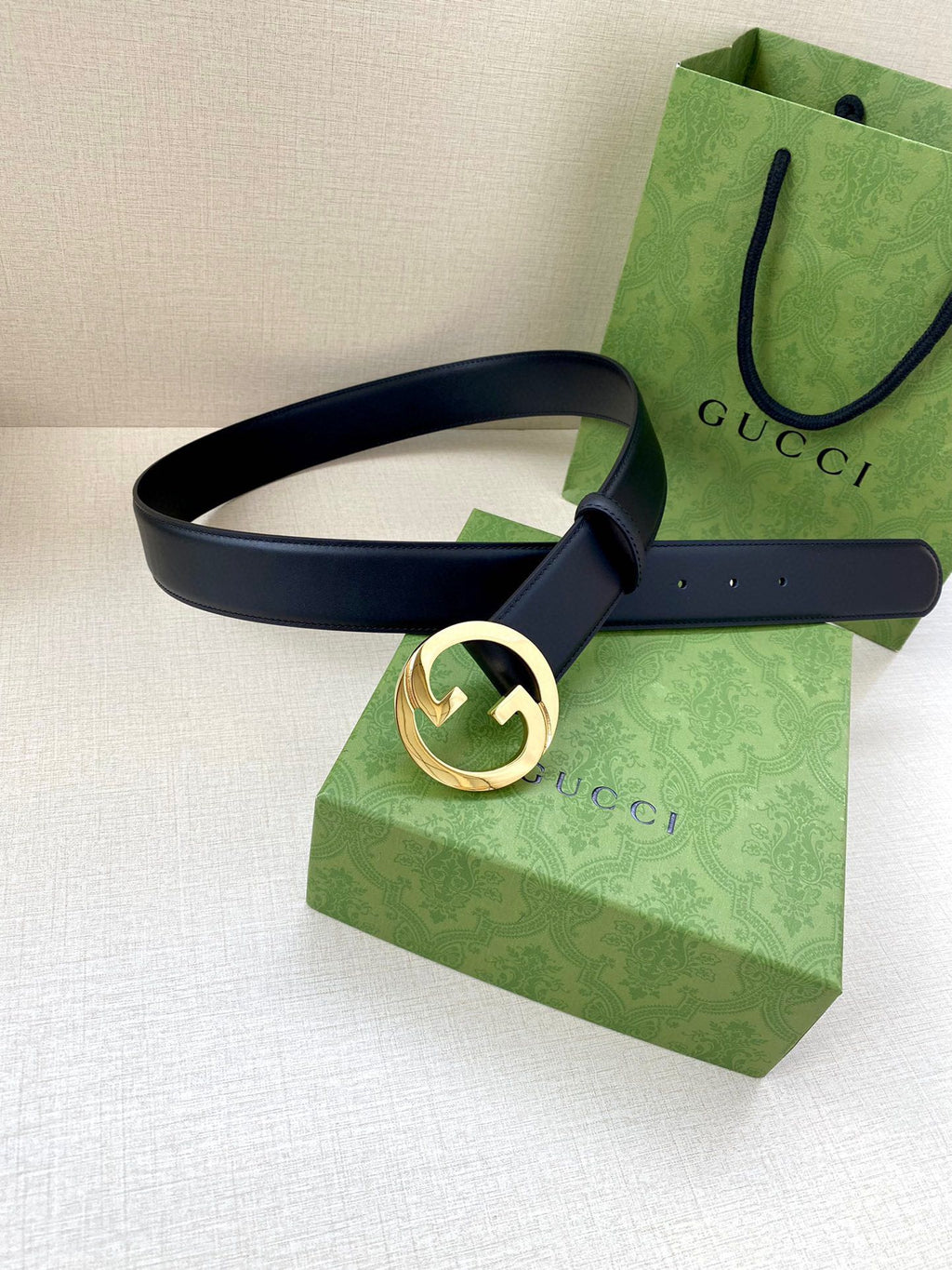 Gucci belt with dark blue leather strap and gold interlocking G buckle