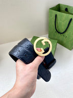 Gucci navy leather belt with embossed GG texture and gold-tone double G buckle