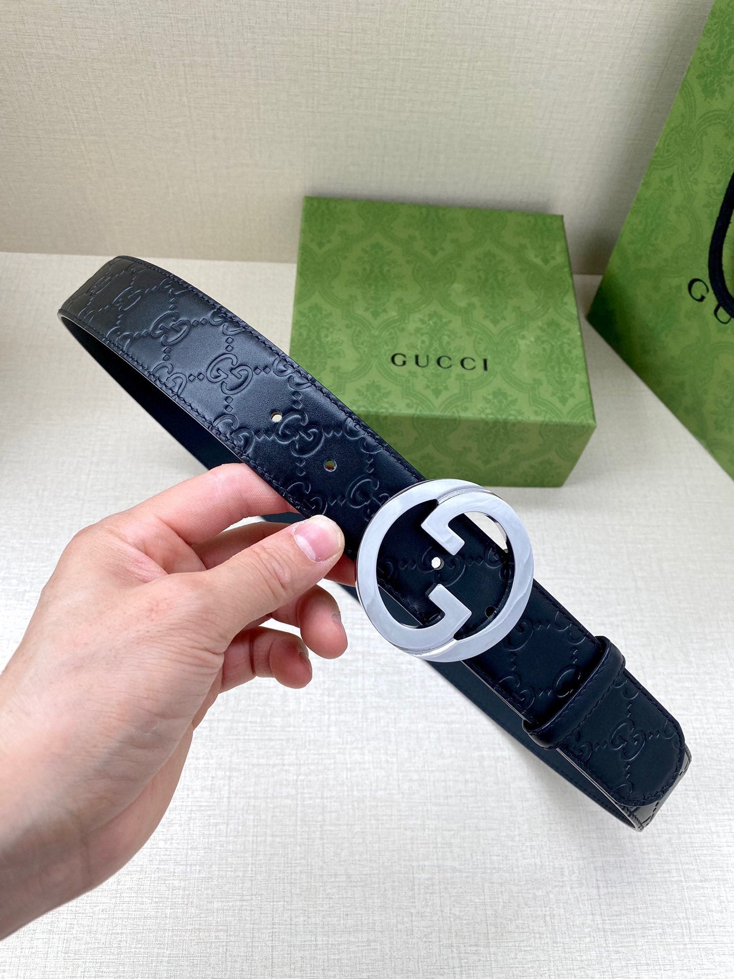 Gucci navy leather belt with embossed GG pattern and silver-tone double G buckle