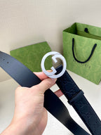 Gucci navy leather belt with embossed GG pattern and silver-tone double G buckle close-up