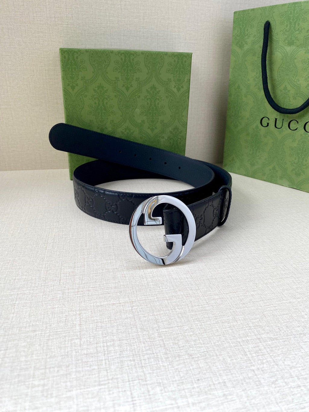 Gucci navy leather belt with embossed GG texture and silver-tone double G buckle