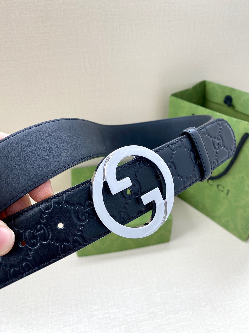 Gucci navy leather belt with embossed GG texture and silver-tone double G buckle