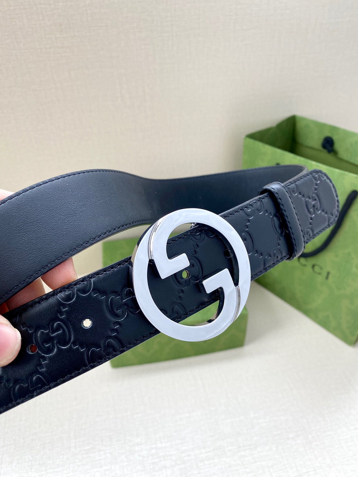 Gucci navy leather belt with embossed GG texture and silver-tone double G buckle