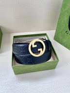 Gucci navy leather belt with embossed GG pattern and gold-tone double G buckle