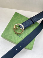 Gucci navy leather belt with embossed GG pattern and gold-tone interlocking G buckle