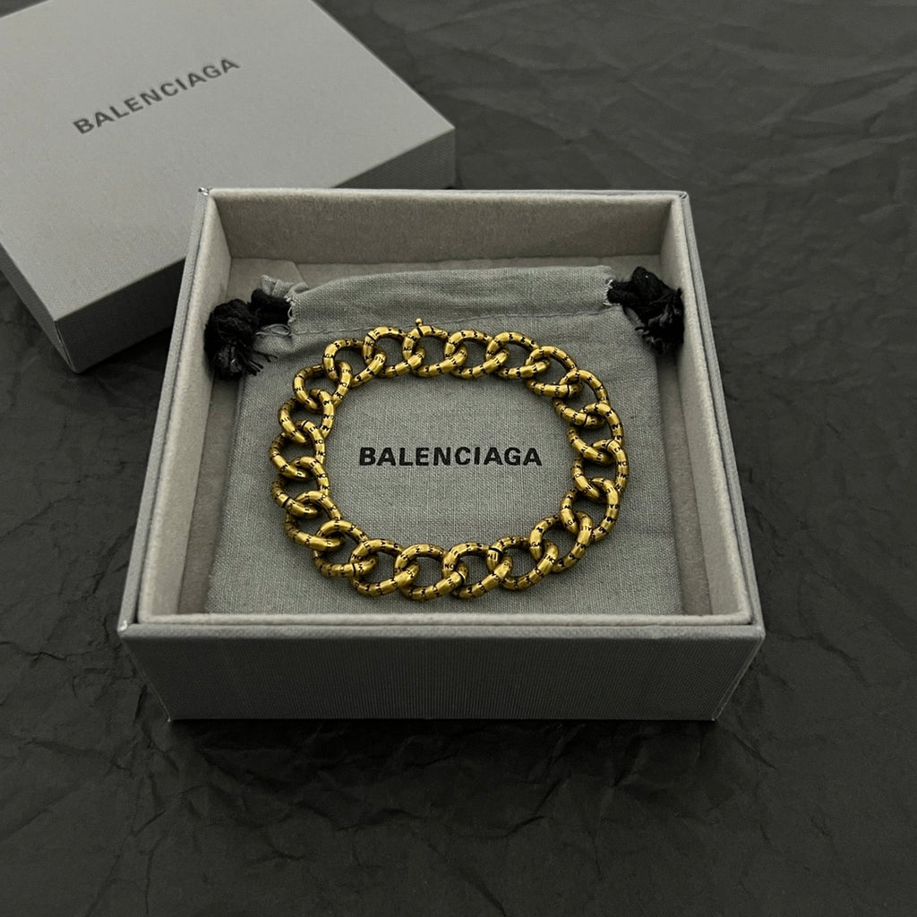 Balenciaga gold-tone chain bracelet with BALENCIAGA logo plate and black tassel ends