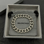 Balenciaga chain bracelet with silver-tone links and black fabric ties in open box