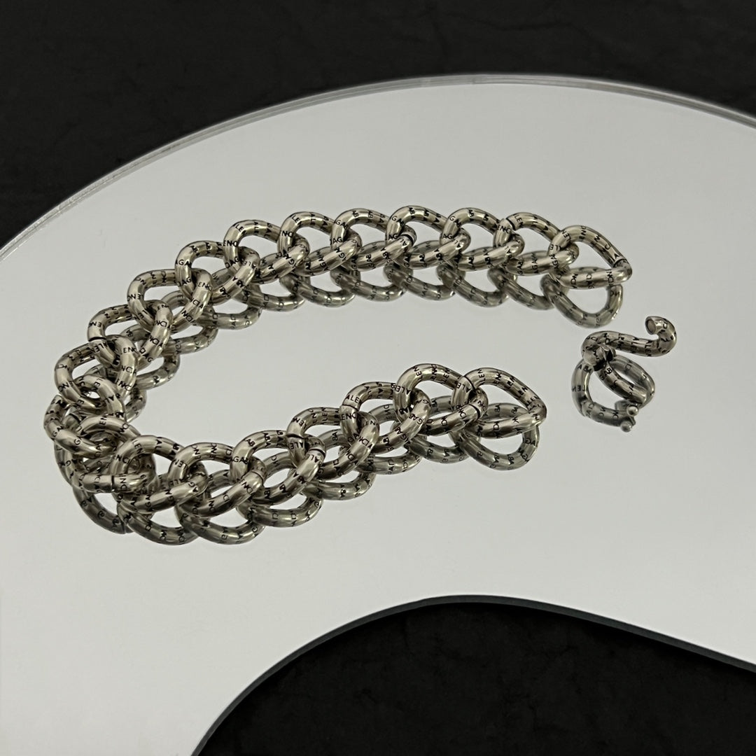 Balenciaga chain bracelet with silver-tone links close-up on white display stand