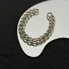 Balenciaga chain bracelet with silver-tone links on white display stand