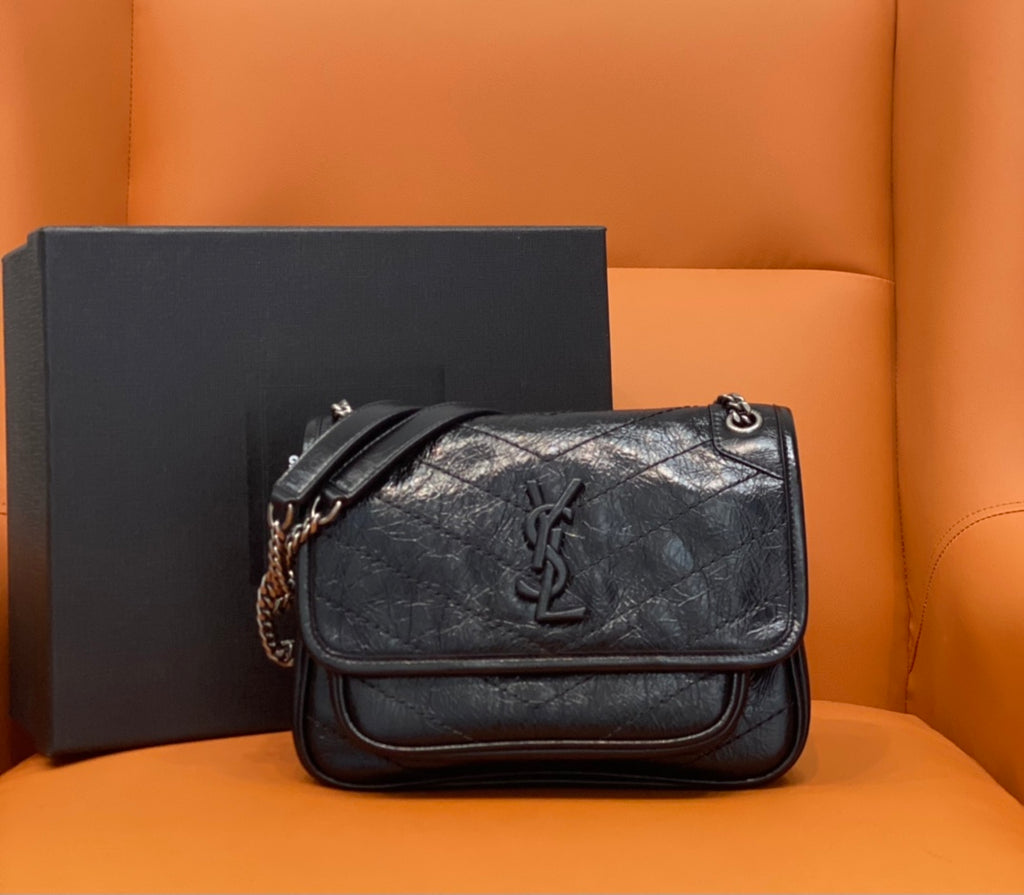 Black quilted leather crossbody bag with YSL logo on front flap and chain strap