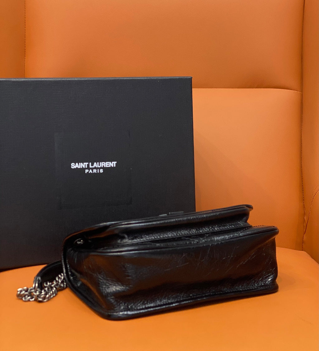 Black leather flap bag with chain strap and stitched panel detail