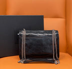 Black quilted leather shoulder bag with YSL logo, flap front, and double chain strap