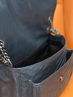 Saint Laurent bag interior view with zip pocket and quilted dark blue leather lining