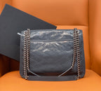 Saint Laurent shoulder bag with front flap, silver chain handles, and quilted leather body