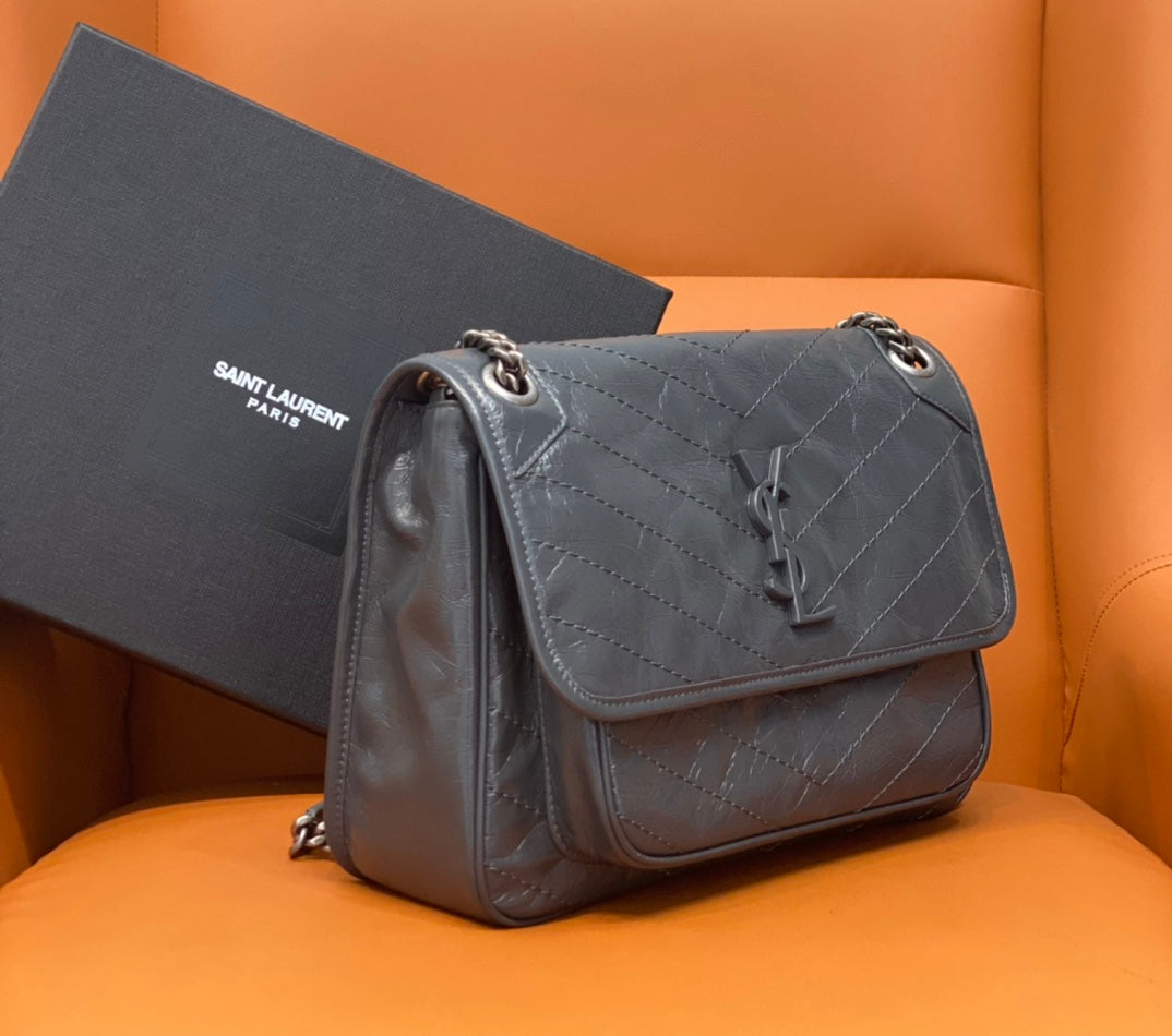 Saint Laurent crossbody bag with quilted leather, top flap, and chain shoulder strap