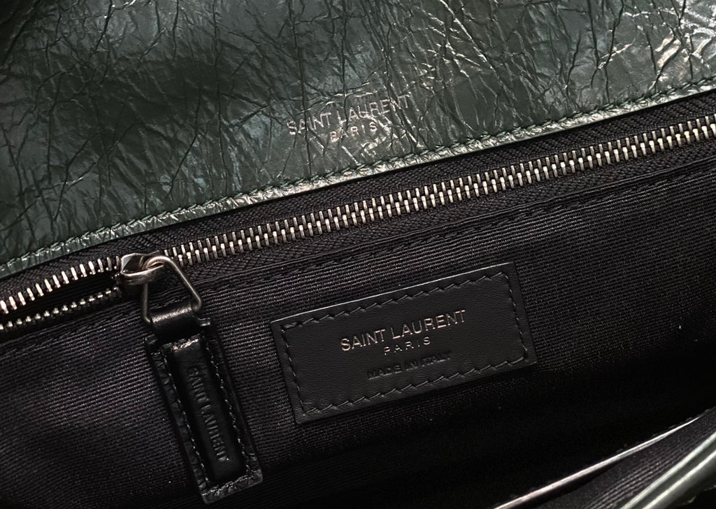 Black lined interior with Saint Laurent zip label and metal zipper pull