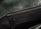 Black lined interior with Saint Laurent zip label and metal zipper pull