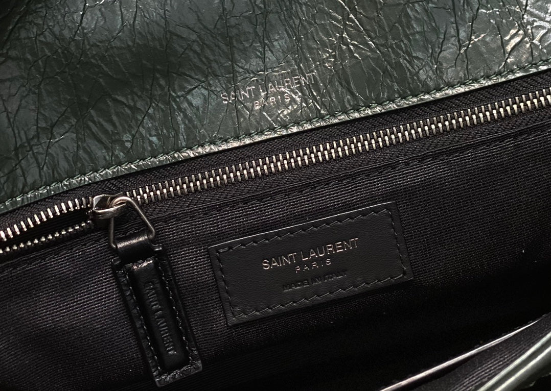 Black lined interior with Saint Laurent zip label and metal zipper pull