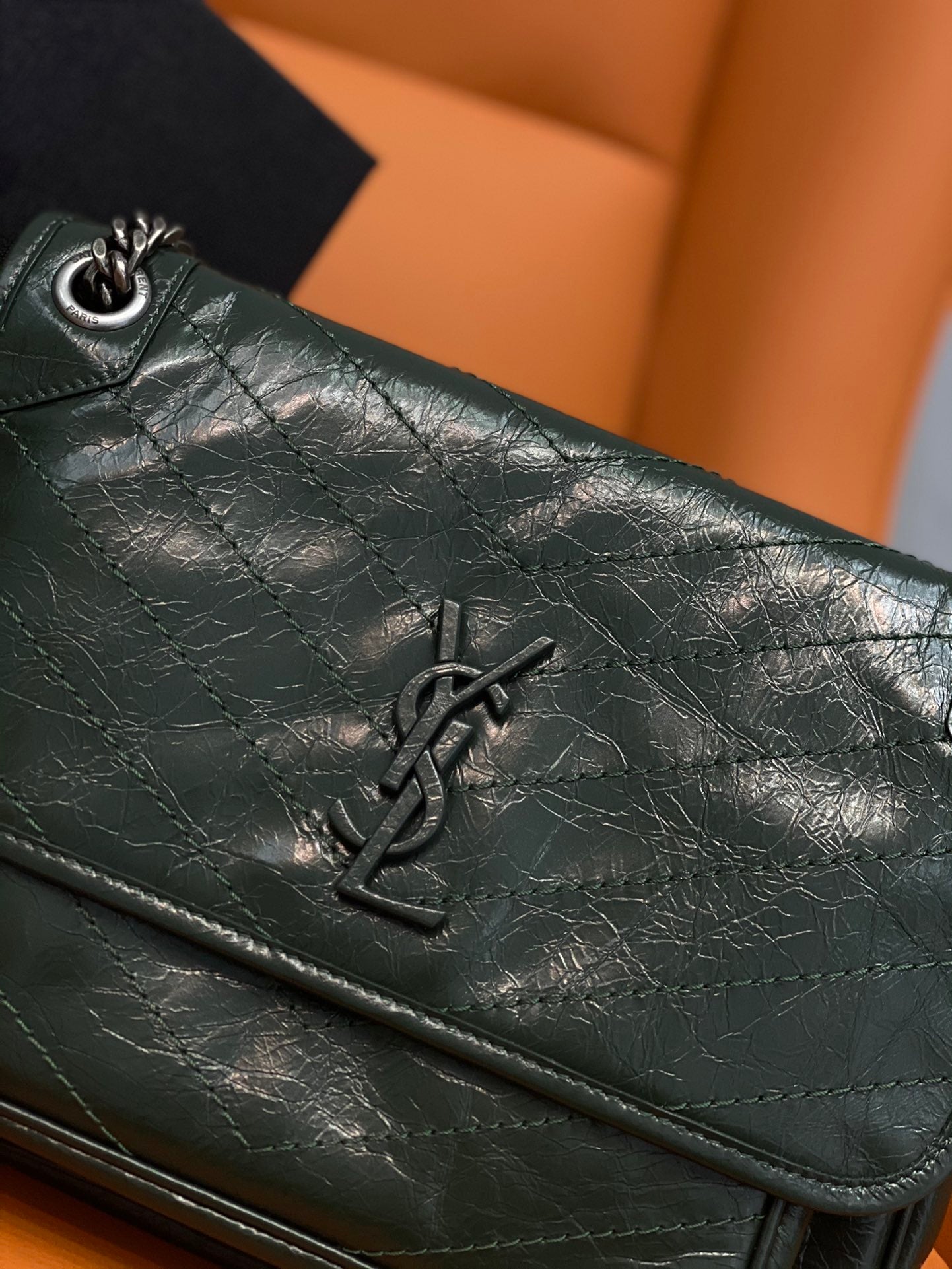 Dark green leather flap bag with YSL monogram and quilted stitching