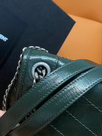 Dark green leather bag with chain strap and embossed logo on flap