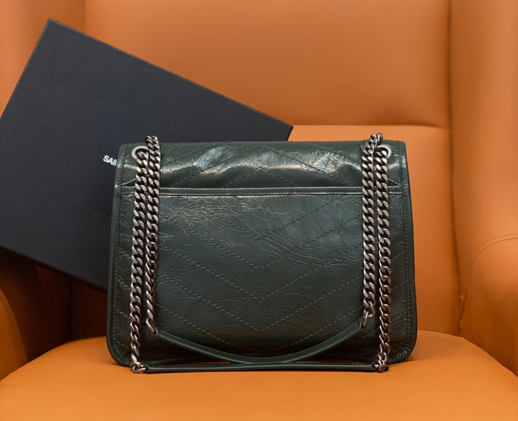Dark green leather flap shoulder bag with chain handles and stitched panels