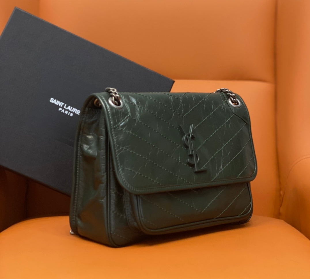 Dark green leather shoulder bag with flap, chain strap, and snap closure