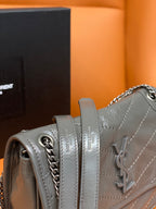 Leather shoulder bag side panel with chain strap and stitched detail, light gray