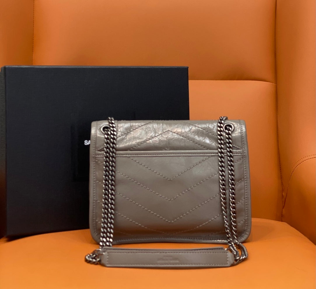 Small Saint Laurent shoulder bag with quilted front, double chain strap, and flap closure